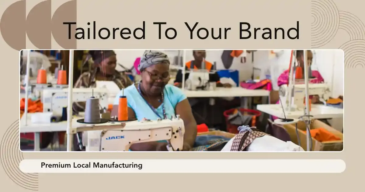 Sewing team at work in the Cape Town workshop under a Tailored To Your Brand banner
